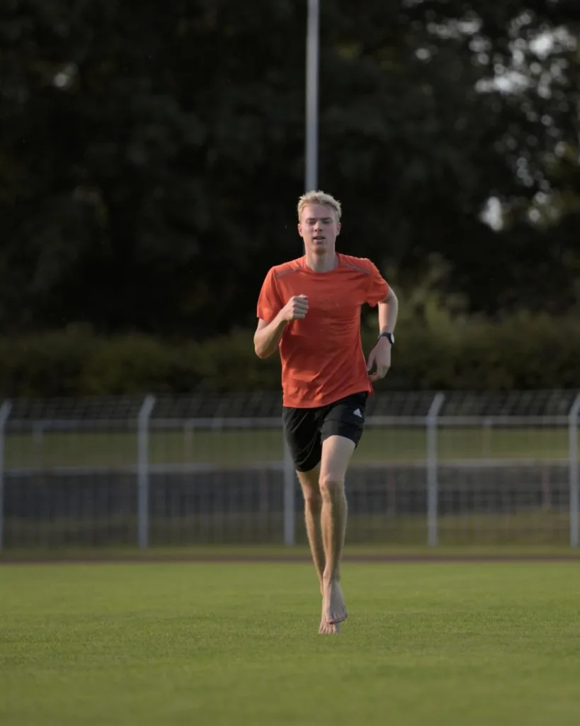 Emil running barefoot on grass